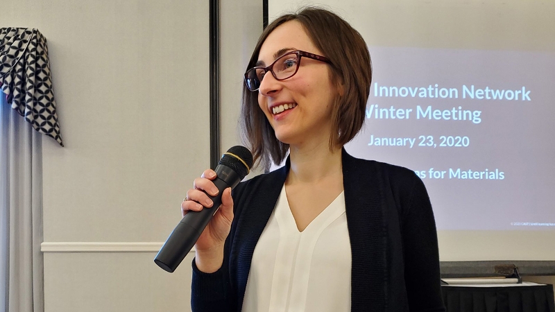 Kasia Derbiszewska giving a presentation in front of a screen